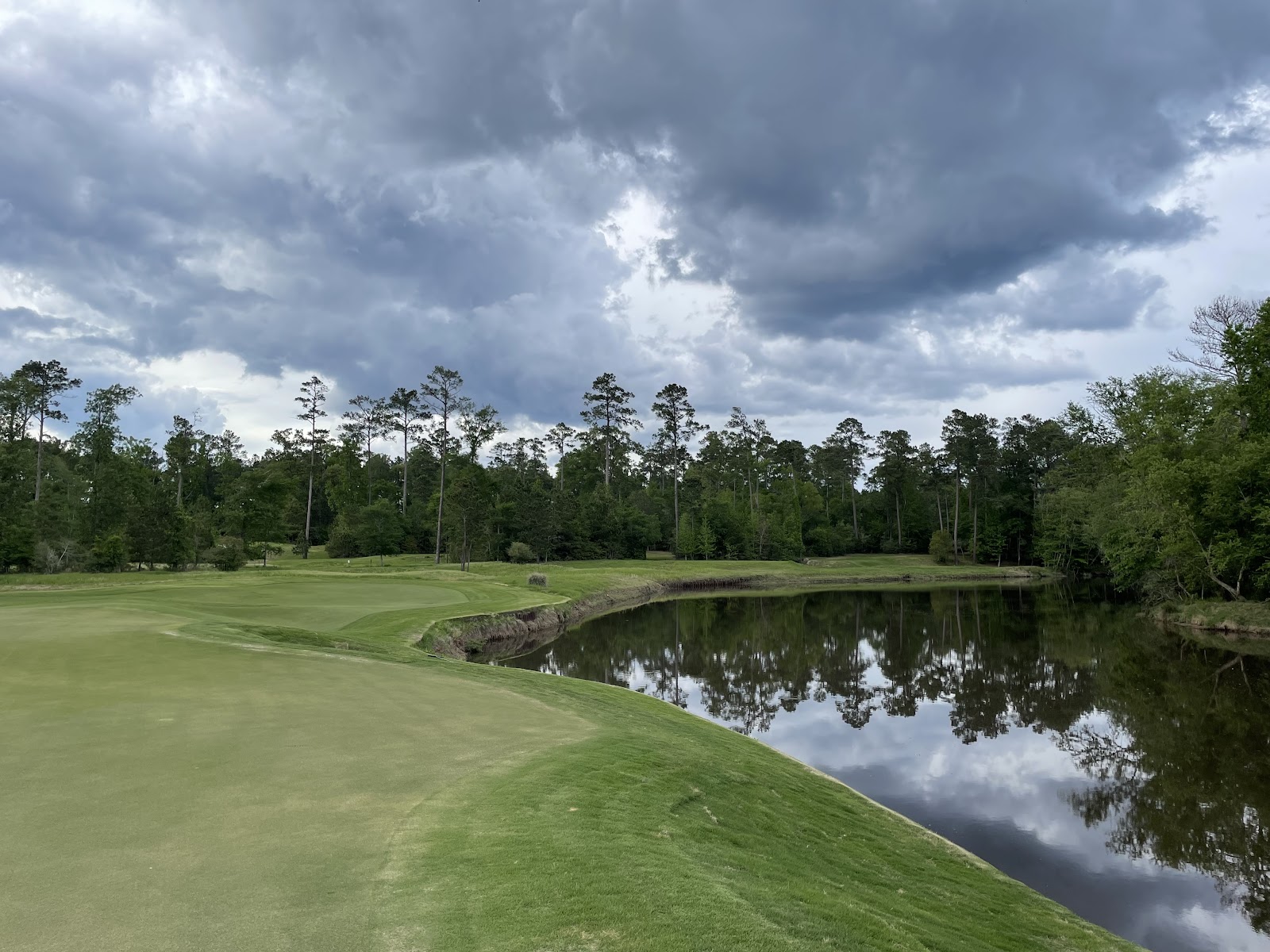 Whispering Pines Golf Club, Texas, fairway framed by tall pines and water