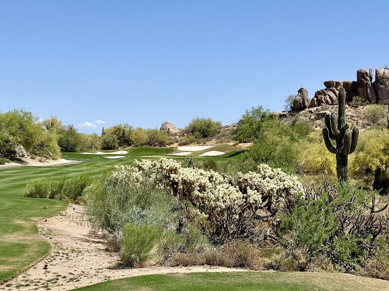 A Scottsdale golf resort at dusk, pools and fairways below the desert mountains