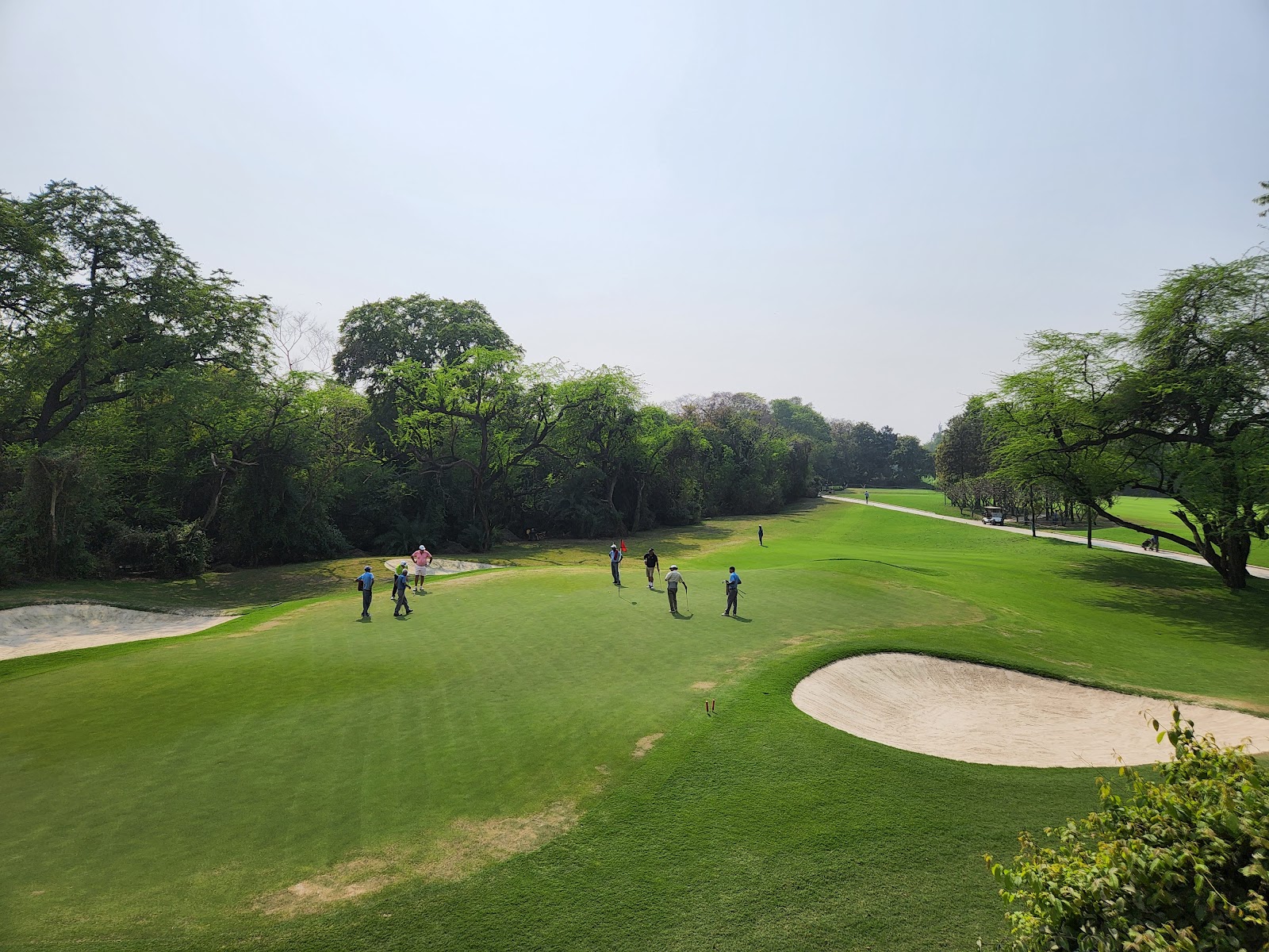 Delhi Golf Club, the Lodhi Course with a Mughal era tomb beside a mature parkland fairway in New Delhi, India
