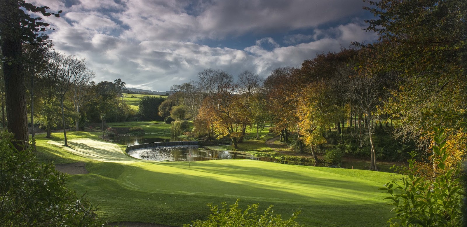 Druids Glen golf course in County Wicklow, water lined parkland fairways framed by mature woodland