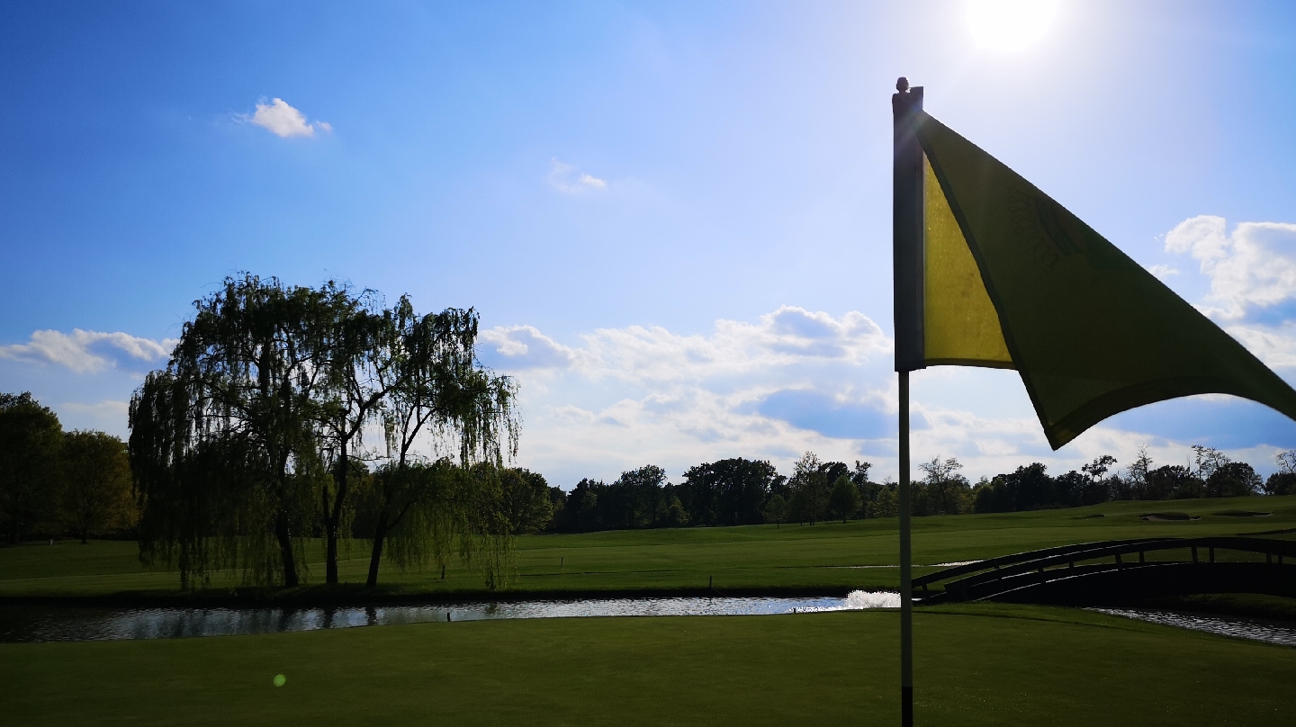 Golf Club Castelconturbia, wooded parkland fairway near Agrate Conturbia in Piedmont, Italy, with the Monte Rosa massif beyond