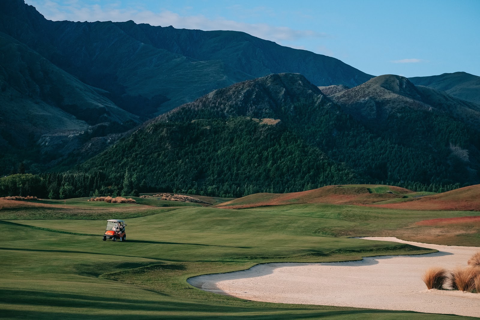 The Hills Golf Club, fairway framed by schist tors and snow capped peaks near Arrowtown, New Zealand
