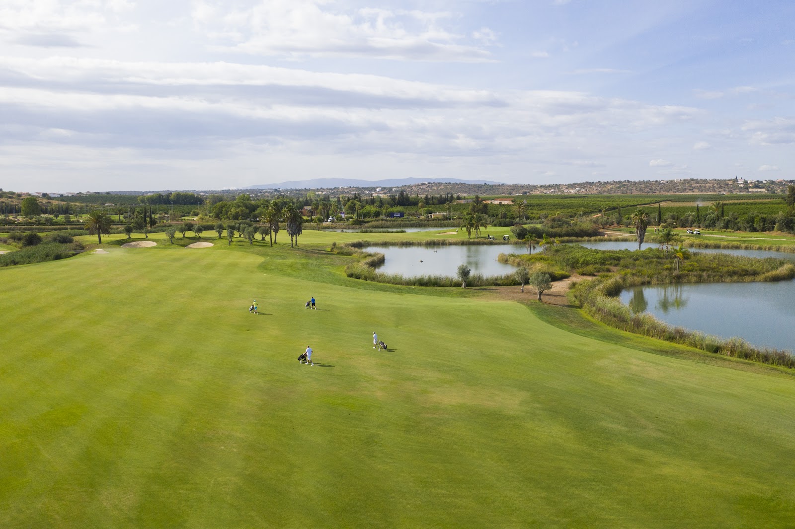Amendoeira O'Connor Jnr Course, parkland fairways with palms and lakes in the western Algarve
