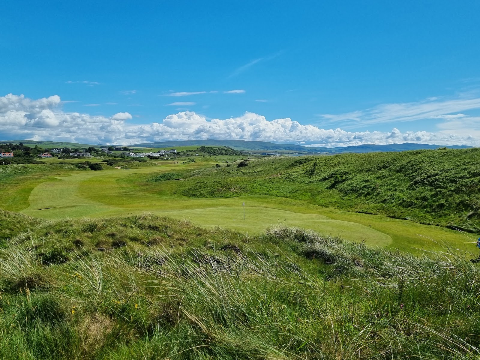 Turnberry Ailsa Course, links holes along the Ayrshire shore beneath the lighthouse with Ailsa Craig offshore, Scotland