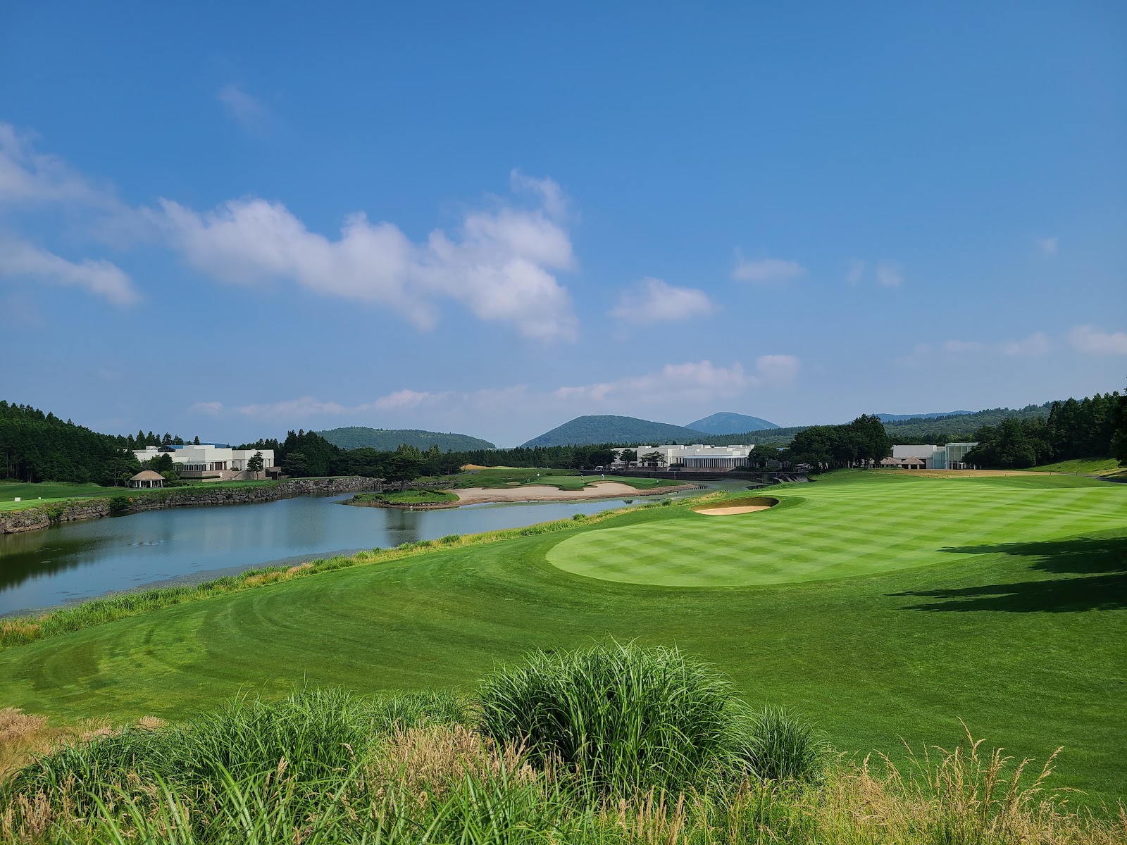 The Club at Nine Bridges, Jeju, fairway and water hazard below the slopes of Mount Halla, South Korea
