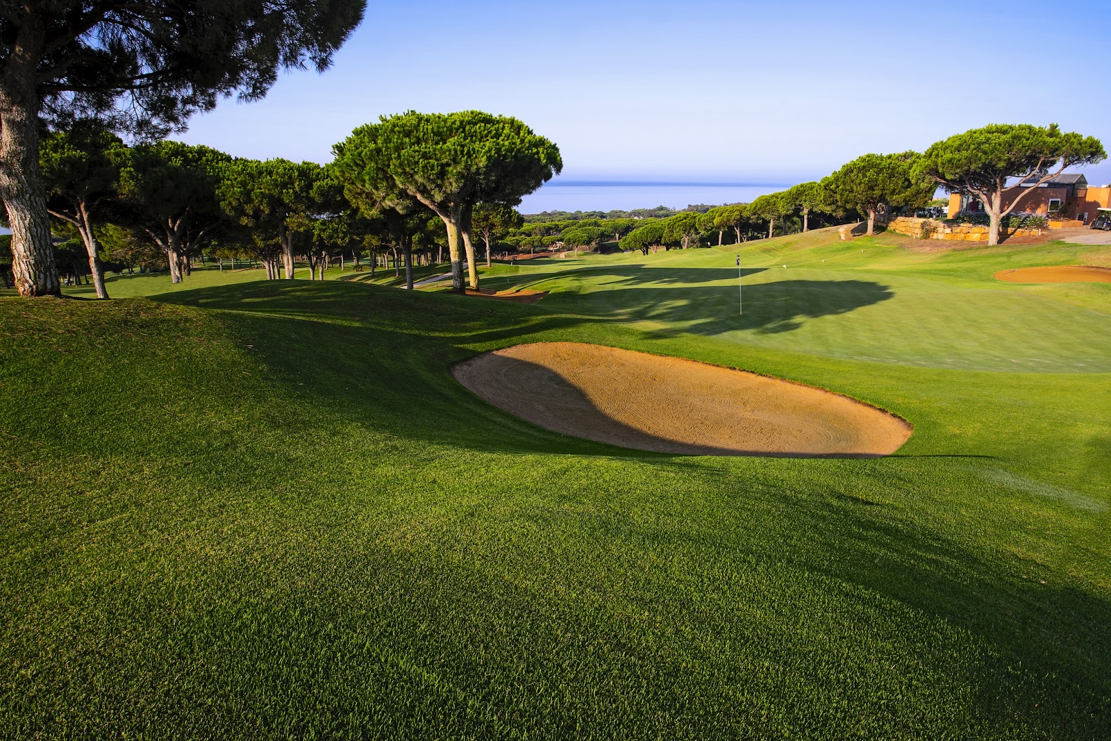 Cabopino Golf Marbella, hilly fairway above the dunes and marina on the eastern edge of Marbella, Spain