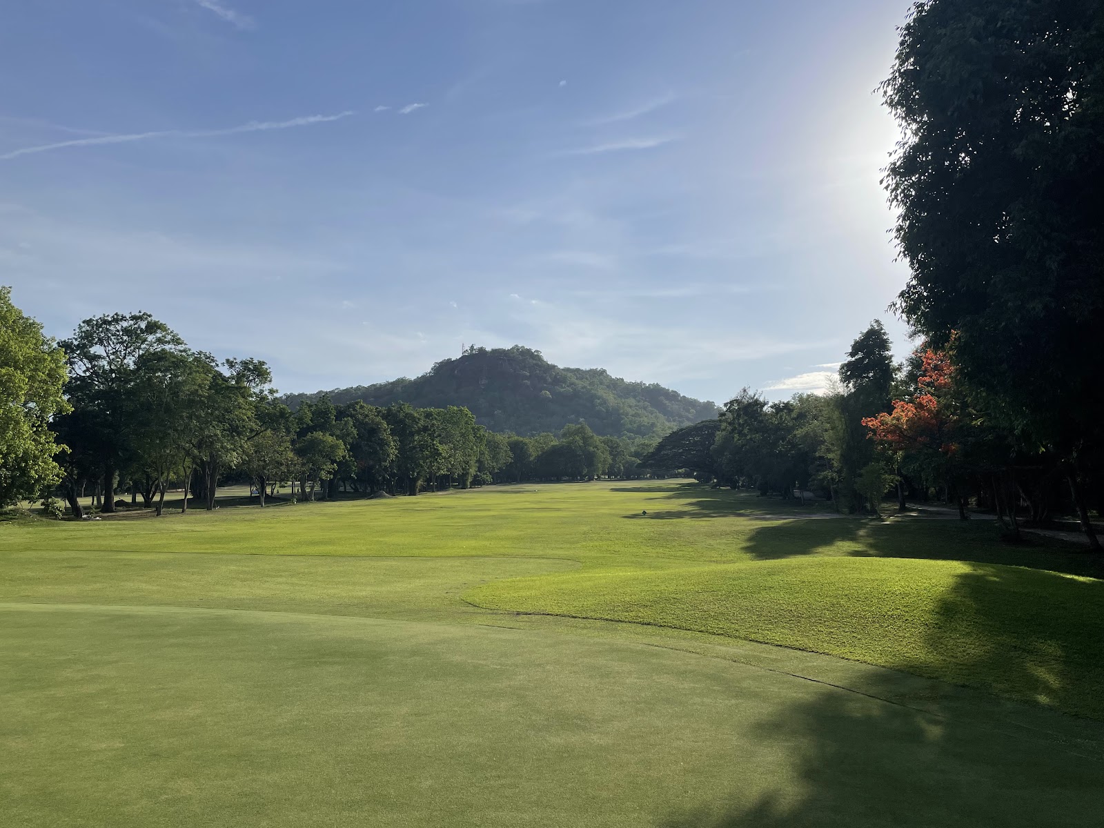 Royal Hua Hin Golf Course, Thailand's oldest course, fairways lined with mature trees beneath rocky hills near the famous railway station