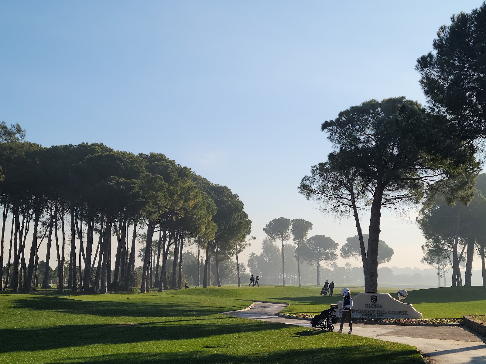 Gloria Verde Golf Course, a pine framed fairway and lake at the Gloria complex in Belek, Antalya, Turkey