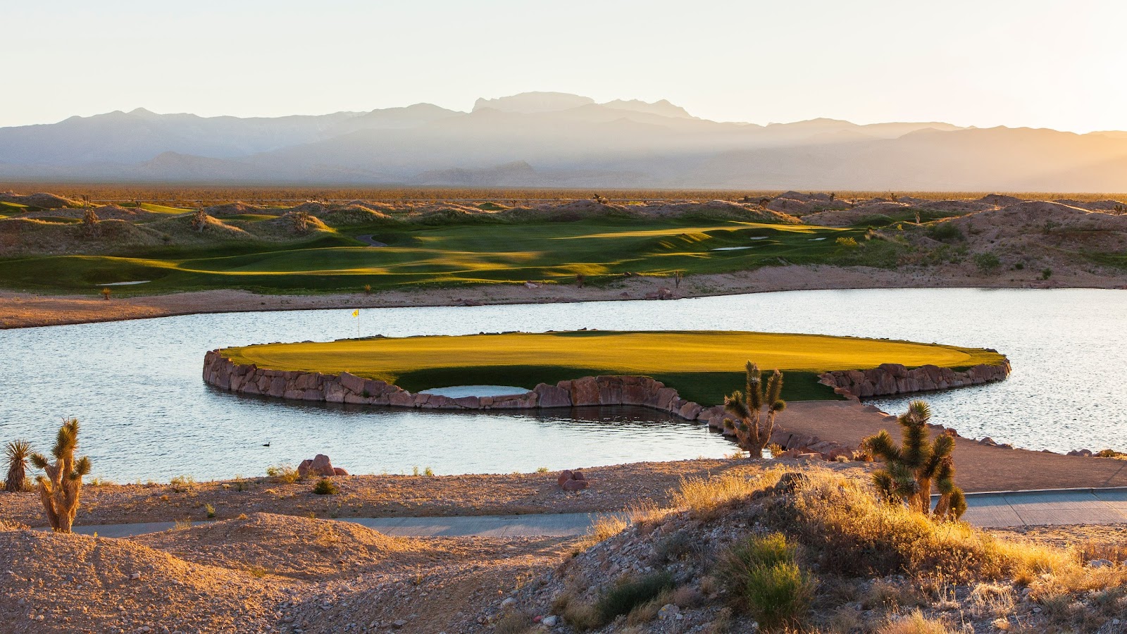 Las Vegas Paiute Wolf Course, green fairways threading through open Mojave Desert at the foot of Snow Mountain north of Las Vegas, Nevada