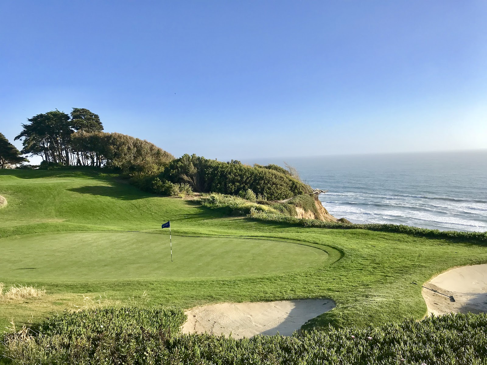 The Olympic Club Lake Course, tree lined sloping fairway above Lake Merced in San Francisco