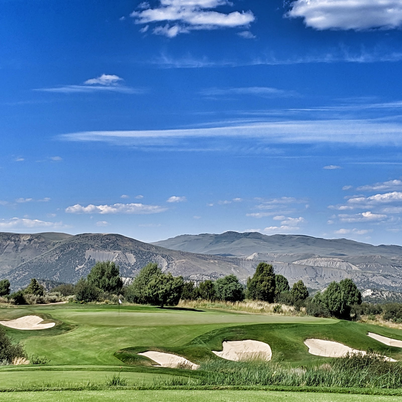 Red Sky Golf Club Fazio Course, mountain fairway rising through sage near Wolcott, Colorado