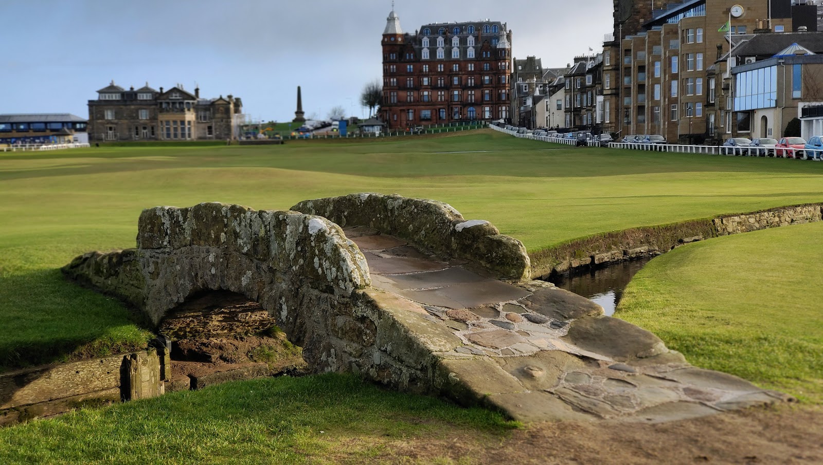 The Swilcan Bridge on the 18th hole of the Old Course at St Andrews, clubhouse and town behind