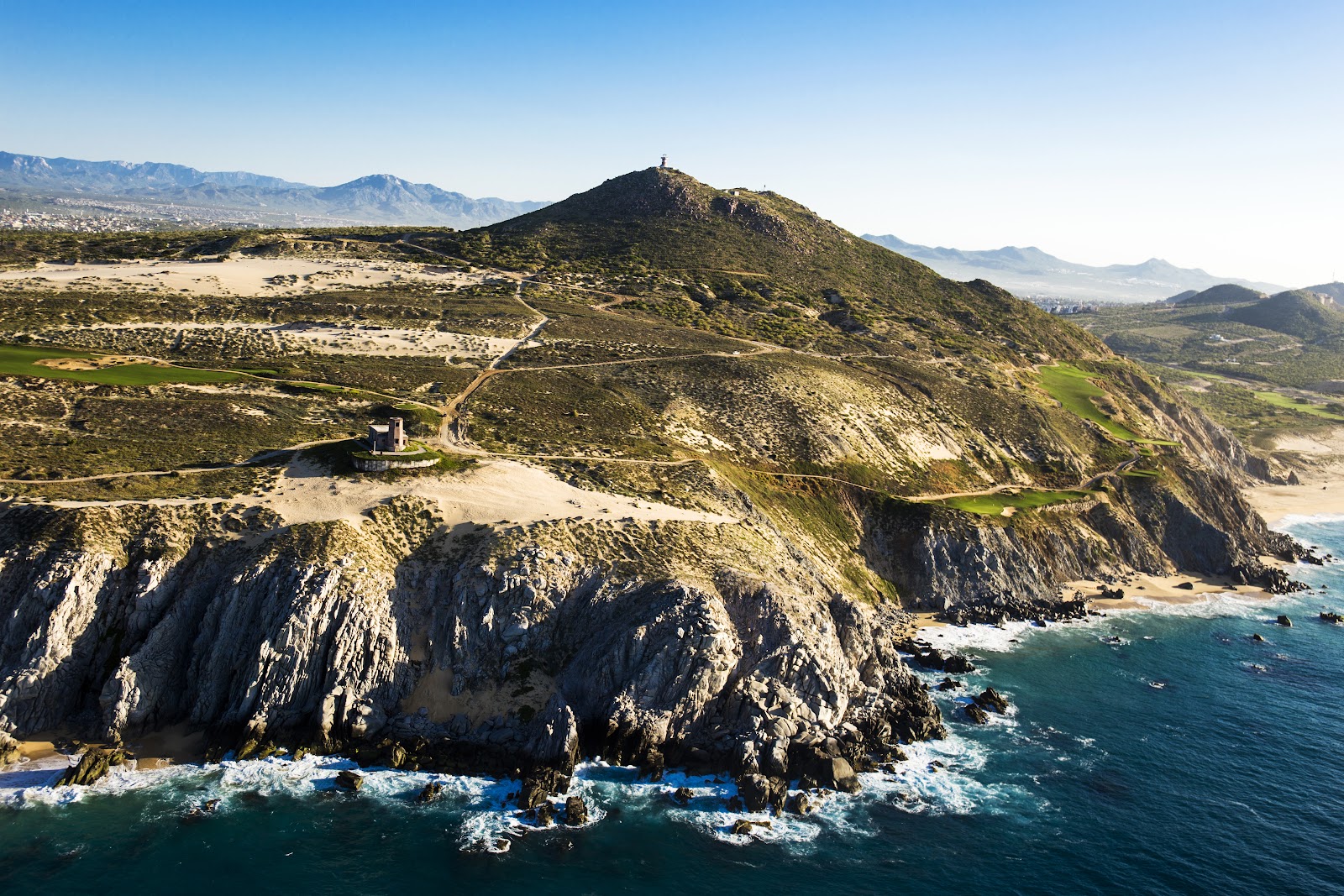 Oceanside desert golf course at Quivira in Los Cabos, Mexico, illustrating the best months to play golf in Mexico