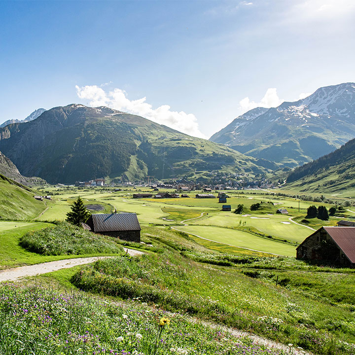 Alpine golf course in Switzerland framed by mountains, illustrating the best months to play golf in Switzerland